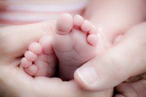 Baby's feet in parent's hand - HighPoint Advisors, LLC
