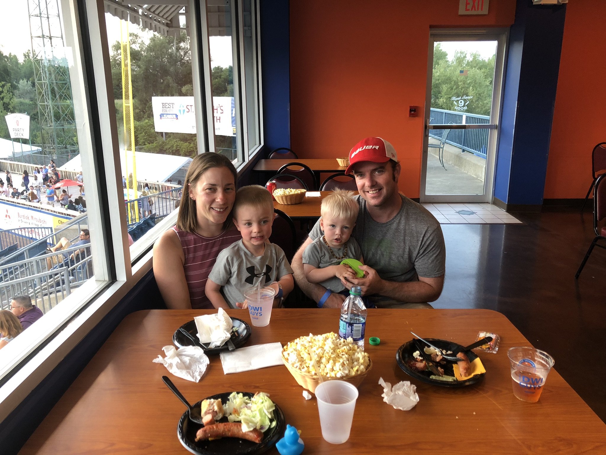 Family enjoying the game with their young children