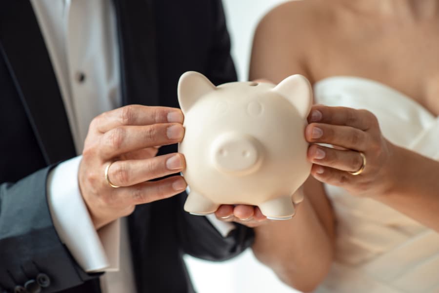 Wedding Couple Holding Piggy Bank