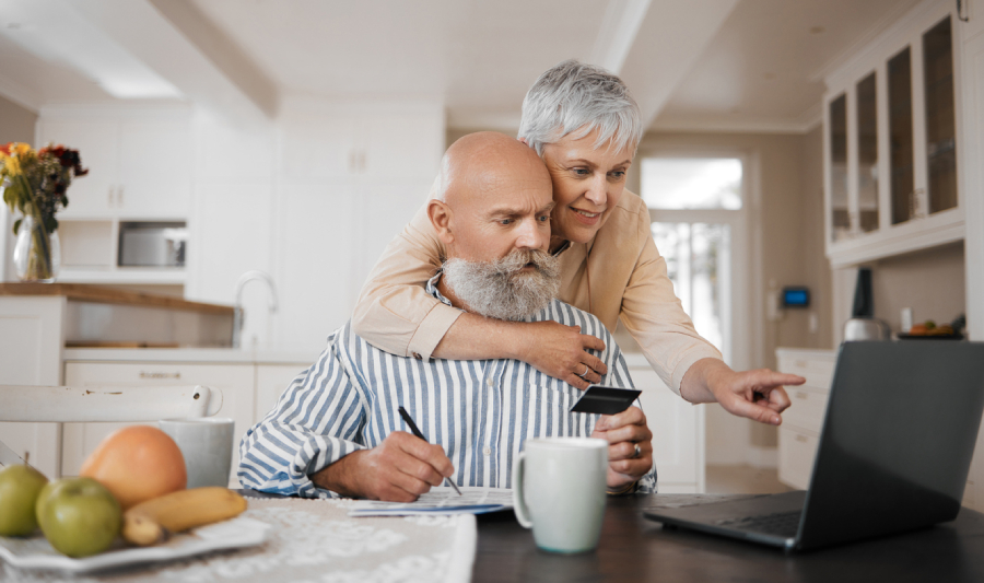 Happy couple looking over their retirement income plan