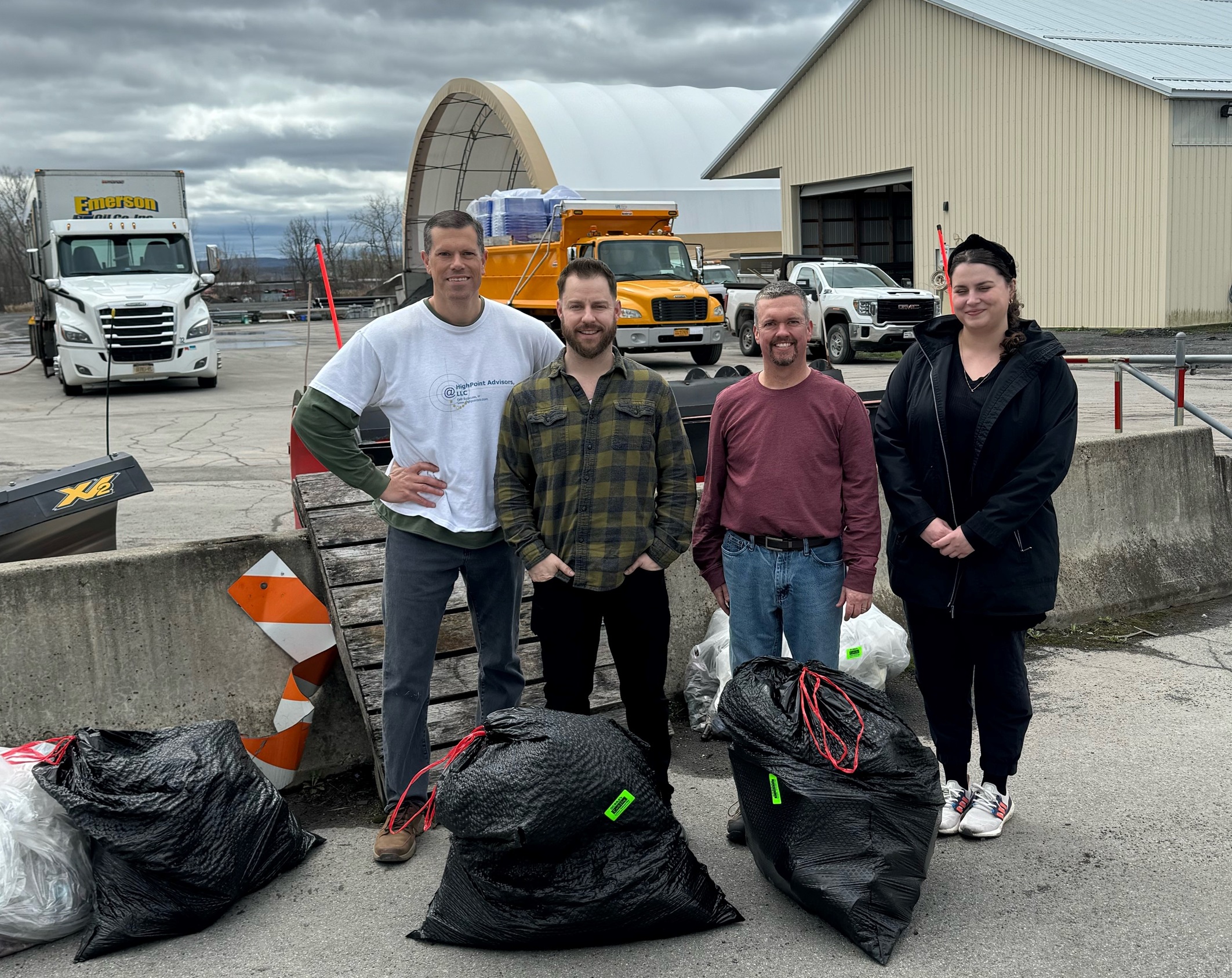 Team at HighPoint Advisors, LLC cleaning up trash in the East Syracuse, NY neighborhoods for Earth Day - OCCRA.