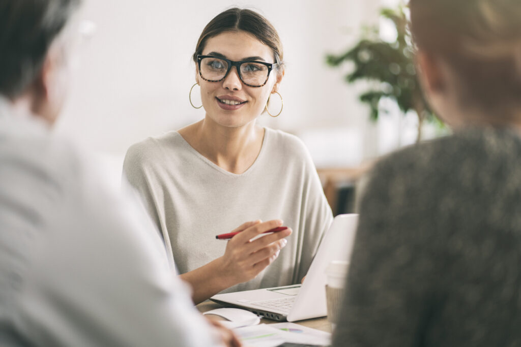 Wealth manager speaks with couple in office