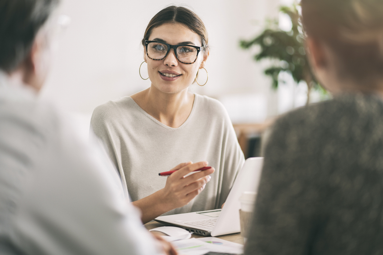 Wealth manager speaks with couple in office