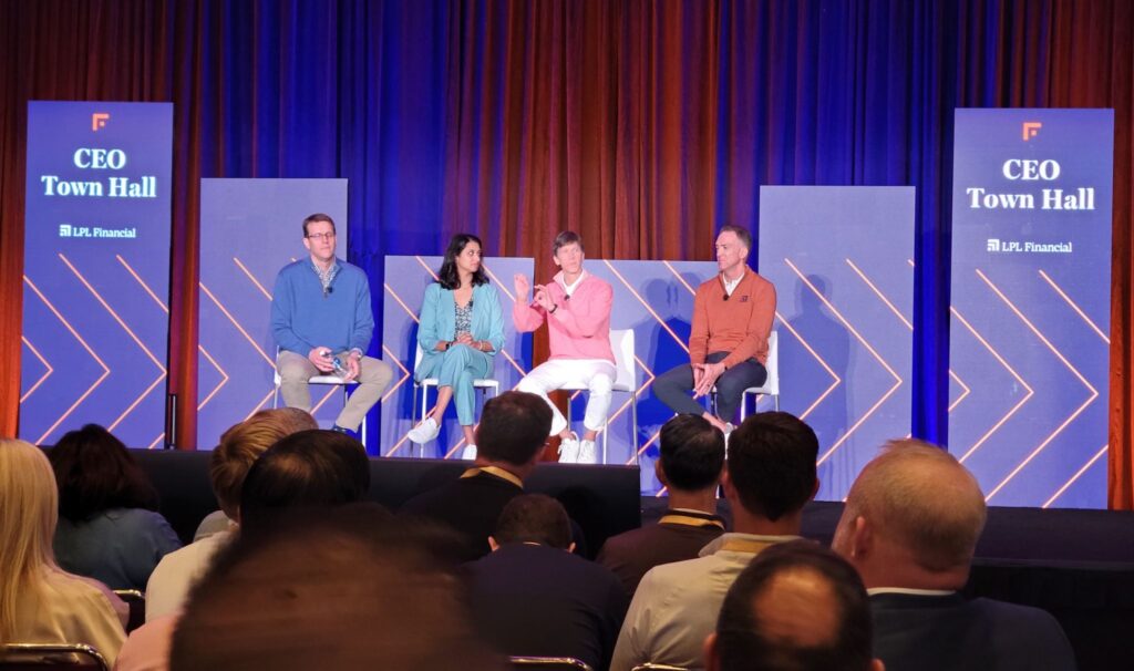 LPL Focus Conference Town Hall in San Diego, with speakers presenting at the front and an engaged audience listening attentively.