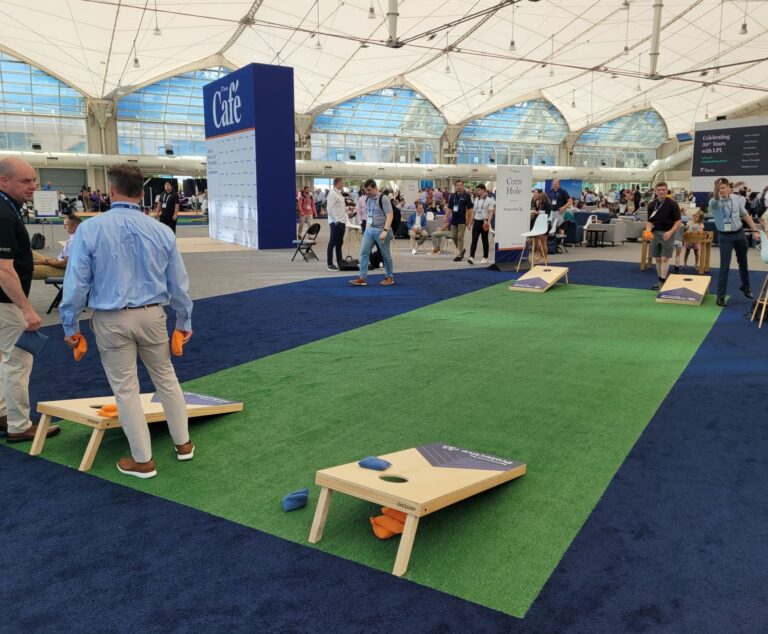 People having fun playing cornhole inside the LPL Focus Conference in San Diego