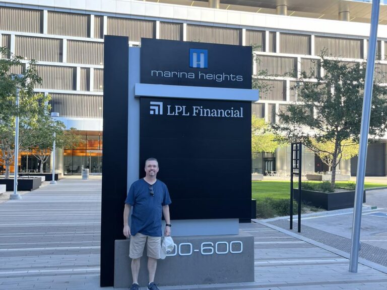 Pat stands outside the LPL Financial building in Tempe, Arizona, with the building's signage visible in the background.