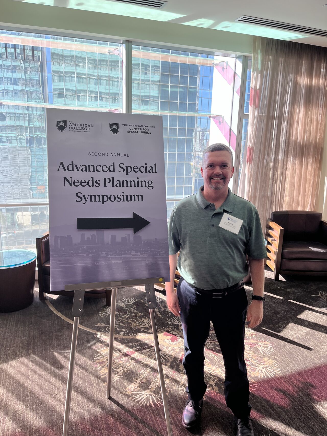 Pat from HighPoint Advisors in Syracuse posing next to the welcome sign for the Advances in Special Needs Planning Symposium in Arizona.